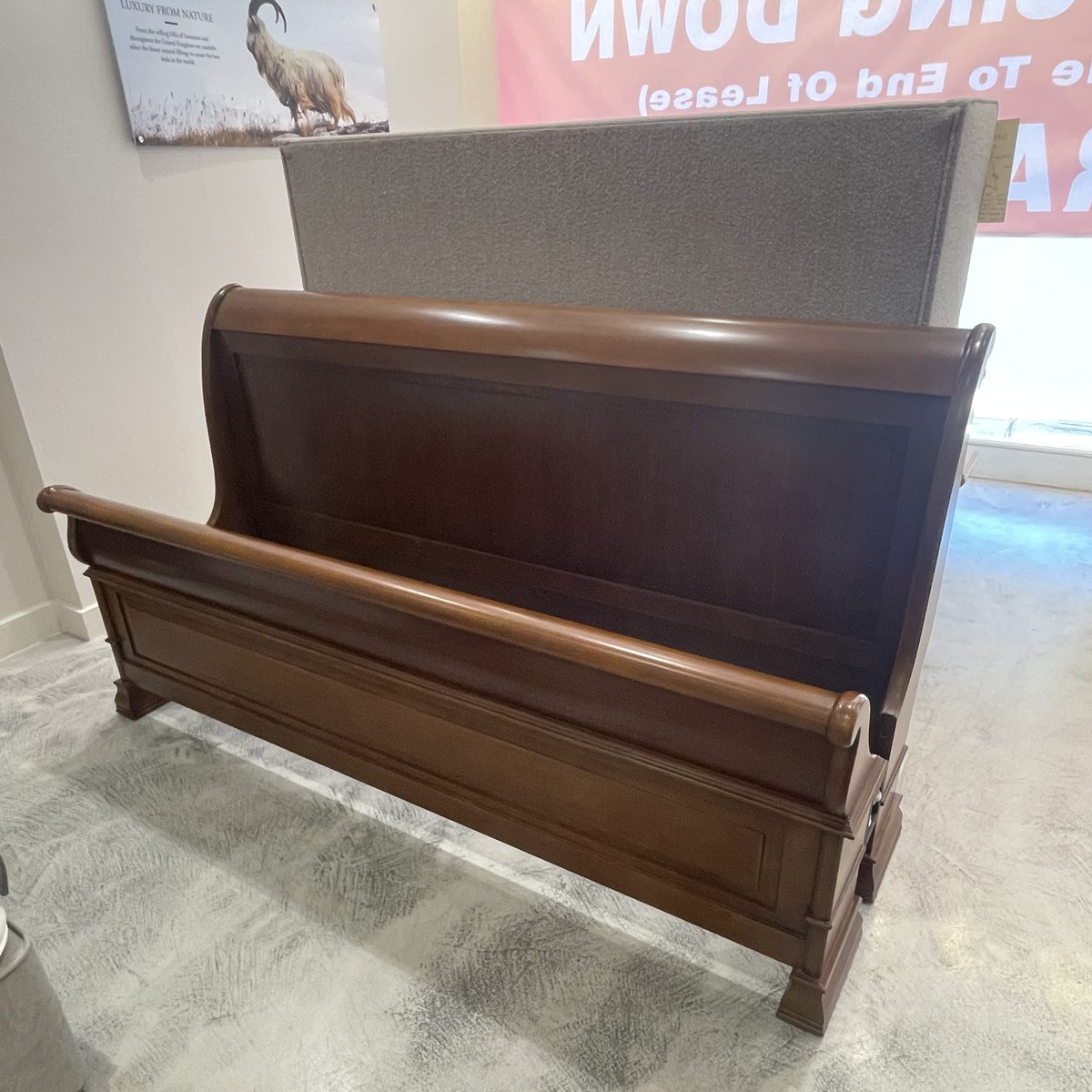 Chatsworth sleigh bed in dark cherry wood in the King's Road showroom
